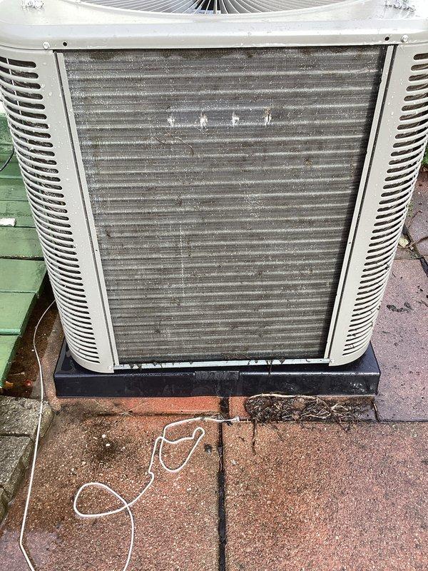 Performed routine air conditioning maintenance on outdoor condensing unit. Inspected heavily soiled condenser coils and air filter showing significant dirt and debris accumulation, assessed refrigerant lines and electrical components, and documented unit condition requiring cleaning to maintain optimal system efficiency.