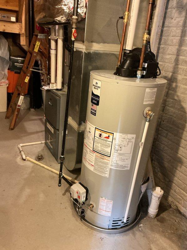 Installed a 50-gallon power vent water heater in basement utility area with proper copper supply line connections, brass shut-off valves, and pressure relief valve. Completed all mechanical connections including top-mounted circulation pump, secured piping with wall brackets, and integrated unit with existing HVAC system. Obtained necessary permits and ensured all installations met code requirements with proper venting and safety components in place.