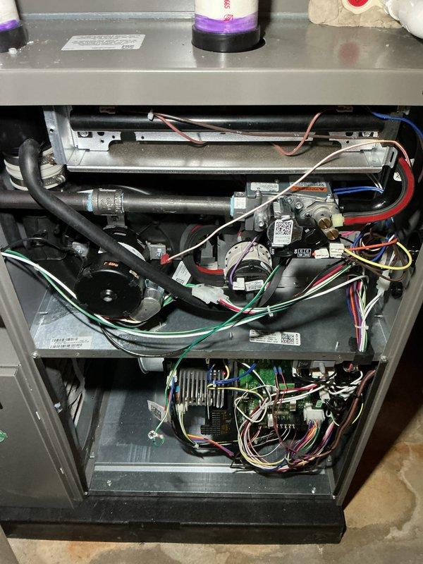 Completed annual heating maintenance on residential furnace system. Performed comprehensive tune-up including inspection of gas valve assembly, burner components, heat exchanger, and blower motor. Verified proper operation of ignition system, flame sensor, and all electrical connections throughout control board and safety circuits. Checked gas pressure, examined venting system integrity, and tested all wire harnesses and connections for secure fitment. Inspected internal compartments for proper airflow and component condition. System operating within manufacturer specifications with all safety controls functioning properly. Unit ready for heating season with no deficiencies noted.