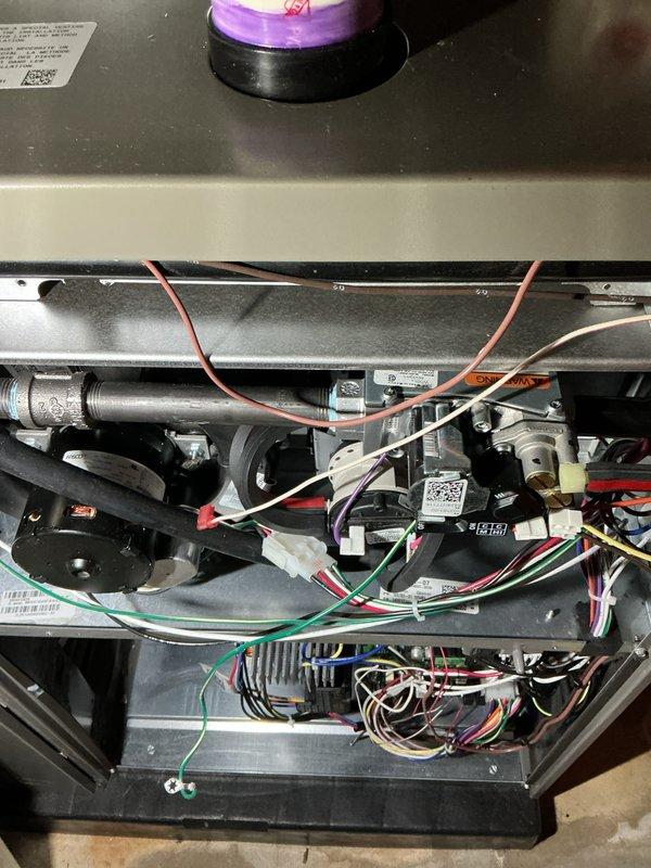 Completed annual heating maintenance on residential furnace system. Performed comprehensive tune-up including inspection of gas valve assembly, burner components, heat exchanger, and blower motor. Verified proper operation of ignition system, flame sensor, and all electrical connections throughout control board and safety circuits. Checked gas pressure, examined venting system integrity, and tested all wire harnesses and connections for secure fitment. Inspected internal compartments for proper airflow and component condition. System operating within manufacturer specifications with all safety controls functioning properly. Unit ready for heating season with no deficiencies noted.