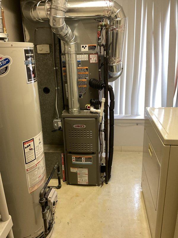 Completed full HVAC system installation including a Lennox 70,000 BTU furnace and 2.5 ton air conditioning unit with rear discharge configuration. Obtained mechanical and electrical permits prior to installation, installed new equipment in utility room with proper ductwork connections, reconnected all necessary components, and verified system operation. Documentation photos captured installed furnace unit with metallic ductwork and complete system setup in residential mechanical space.