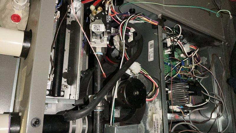 Completed annual furnace tune-up and maintenance on residential HVAC system during evening appointment window. Performed comprehensive inspection of blower motor assembly, electrical connections, and control boards; verified proper operation of all mechanical components including dual blower fans and condensate drainage system. All colored wire connections, relay modules, and circuit boards inspected and confirmed secure with no issues found; unit operating within normal parameters and ready for upcoming heating season.