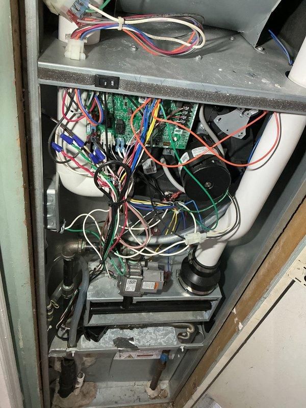 Completed annual heating system tune-up and maintenance inspection as part of preventative care membership. Performed comprehensive system evaluation including blower motor assembly, electrical connections, control board operation, and condensate drainage system. All components inspected and found operating within normal parameters; exterior ventilation grate and interior cabinet components documented with photos showing system in serviceable condition.