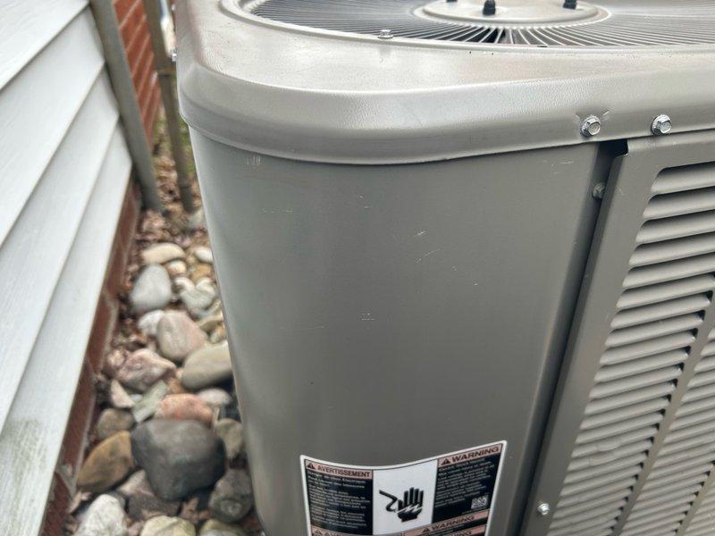 Performed routine AC maintenance on outdoor condensing unit. Inspected and painted electrical access door panel to prevent corrosion and maintain weather protection. Unit operational and in good working condition upon completion.