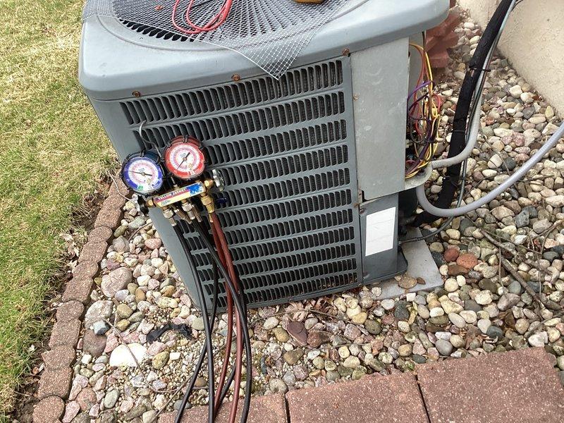 Completed annual air conditioning maintenance on outdoor condensing unit. Performed comprehensive system tune-up including refrigerant pressure diagnostics using manifold gauge set to verify proper charge levels and system performance. Inspected condenser coil fins, electrical connections, and refrigerant lines. Unit operating within normal parameters with no deficiencies noted. System confirmed to be functioning properly upon completion of preventative maintenance service.