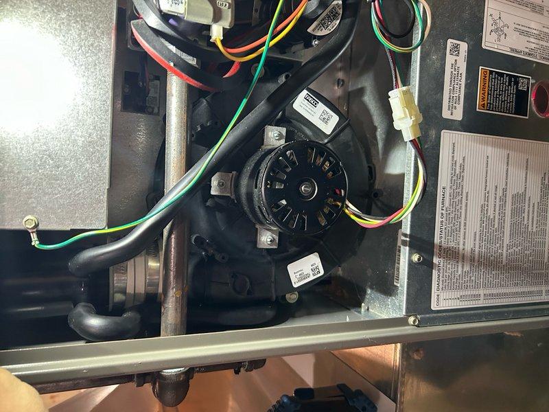 Replaced defective inducer motor assembly on residential HVAC unit under parts warranty coverage. Removed existing motor, installed replacement Lennox component, verified proper electrical connections and wire routing, and tested system operation to confirm draft induction functionality and safe combustion air flow.