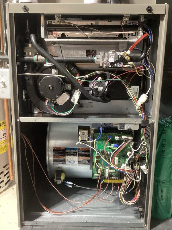 Completed annual heating maintenance tune-up on Lennox furnace system covered under Randazzo Air Care Membership. Performed comprehensive inspection of all internal components including inducer motor assembly, blower motor, gas valve, control board, and condensate collection system. Verified proper operation of digital thermostat displaying heating mode with setpoint at 72°F and current temperature at 67°F. Inspected all electrical connections, wire harnesses, and safety controls throughout upper, middle, and lower compartments of unit. Checked combustion air intake piping, verified secure mounting of all mechanical and electrical components, and confirmed system cycling properly in heating mode. All wiring connections found secure with proper color coding and routing. Control boards and electronic components inspected and found in good operational condition. System operating within normal parameters with no issues identified during maintenance inspection.