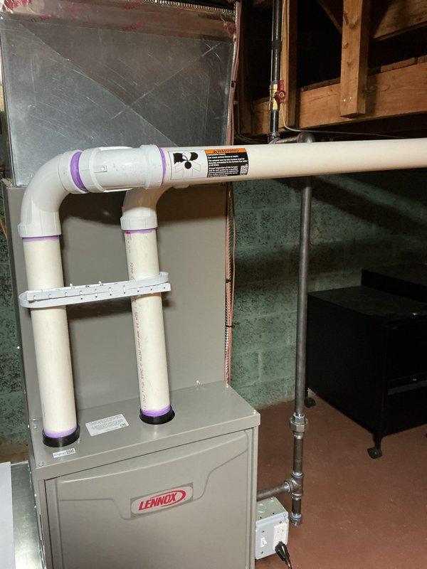 Completed violation repair call back to restore heating system to safe and operable condition following furnace and air conditioning installation. Verified proper operation of Lennox furnace unit with gas and electric connections energized, confirmed PVC condensate drain lines properly installed with secure joints, and inspected refrigerant line set installation to attic-mounted air handler with insulated flexible ductwork. All mechanical systems tested and operational for pending inspection.