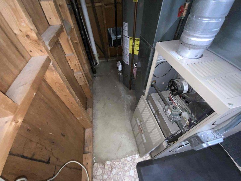 Provided comprehensive estimate for complete HVAC system replacement including both furnace and air conditioning unit in basement location. Assessed 23-year-old existing natural gas furnace and AC system, which is currently operational but nearing end of serviceable life with flame-out scheduled for March 2023. Documented existing equipment configuration, ductwork connections, plenum assembly, and installation space constraints through photographic documentation to develop accurate replacement proposal.