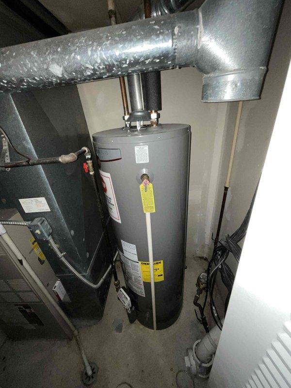 Conducted on-site assessment for furnace replacement in residential owner-occupied property with 31-35 year old existing heating system. Evaluated current HVAC installation including furnace unit with connected PVC venting, copper refrigerant lines, metal plenum ductwork, and flexible aluminum ducting. Documented existing equipment configuration, electrical connections, and mechanical room layout to prepare comprehensive replacement estimate for aging furnace system that has reached end of serviceable life.