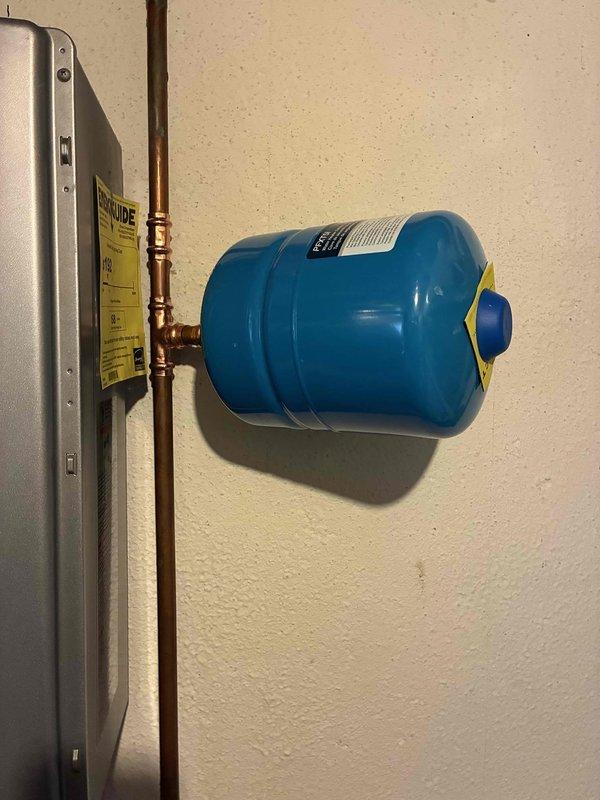 Installed new thermal expansion tank on domestic water system. Mounted blue steel expansion tank horizontally to wall, connected to copper supply piping using compression fittings, and verified proper system pressurization upon completion.