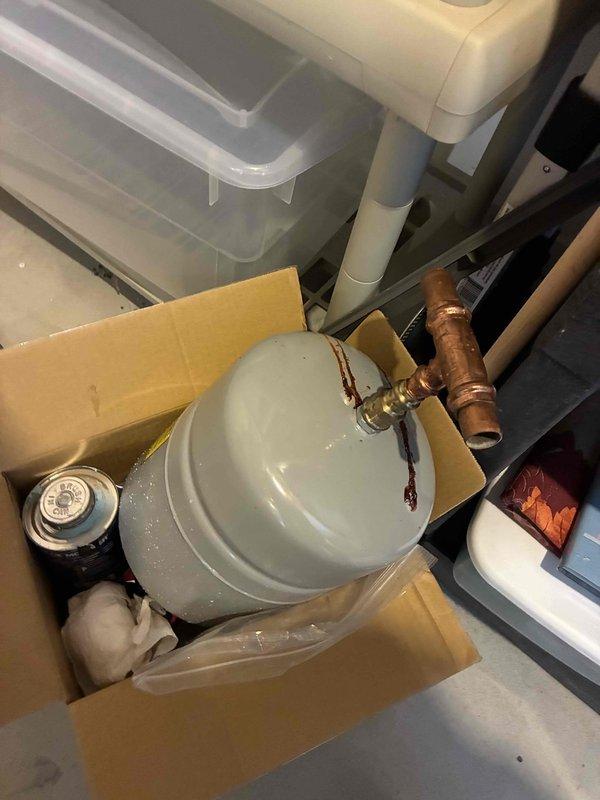 Installed new thermal expansion tank on domestic water system. Mounted blue steel expansion tank horizontally to wall, connected to copper supply piping using compression fittings, and verified proper system pressurization upon completion.