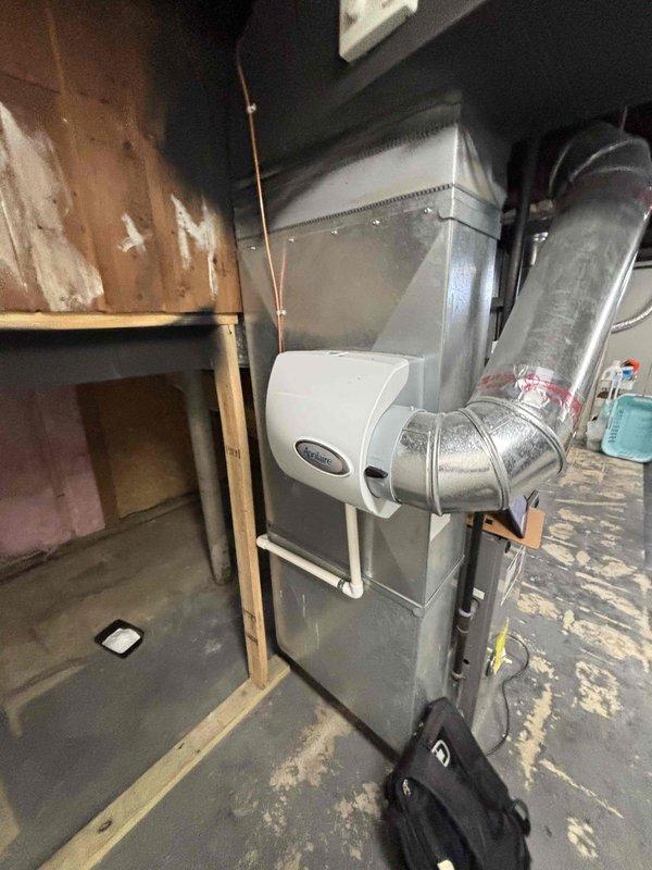 Conducted comprehensive evaluation of existing 10+ year old HVAC system located in basement for equipment replacement estimate. System currently operational with natural gas furnace, Aprilaire humidifier integration, and air conditioning components. Assessed installation environment including existing ductwork configuration, utility clearances, electrical service accessibility, and structural considerations for replacement unit specifications. Documented current equipment condition, duct connections, and ancillary components to provide accurate replacement system recommendations and installation requirements.