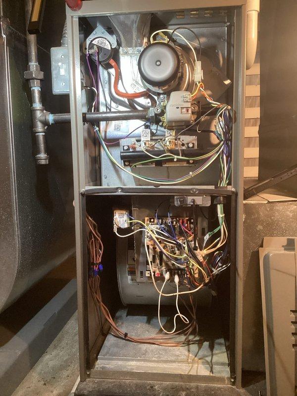 Completed annual ComfortGuard maintenance package on four-year-old furnace and air conditioning system under active warranty. Performed comprehensive tune-up including inspection of blower assembly, control board, electrical connections, and refrigerant lines on furnace unit; verified proper operation of all safety controls and heating components. Conducted outdoor condenser unit inspection with manifold gauge testing to assess refrigerant pressures and system performance. Replaced humidifier filter as requested. Reviewed warranty documentation on site to confirm coverage status. Both systems operating within manufacturer specifications with no deficiencies noted. All components functioning properly on black rubber equipment pad.