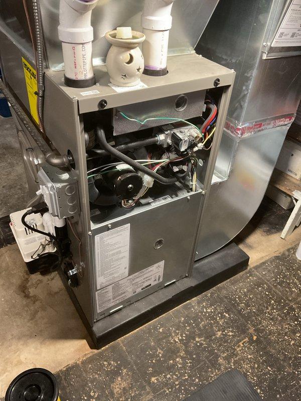 # Annual Heating Maintenance Completed

Performed comprehensive annual heating maintenance on residential furnace unit as part of scheduled Air Care Membership service. Conducted complete system inspection with access panels removed to evaluate all internal components including control board, gas valve assembly, inducer motor, and blower assembly. 

Inspected all electrical connections and wiring harnesses throughout the unit, verifying proper terminations at control board with blue terminals, gas valve connections, and blower motor leads. Examined gas valve operation and associated safety controls. Evaluated inducer motor assembly and verified proper function of draft safety systems. Inspected blower motor compartment and associated components including capacitor and ground wire connections.

Checked all piping, tubing, and ductwork connections for proper installation and secure fastening. Verified cabinet integrity and access panel hardware. Documented system condition through photog