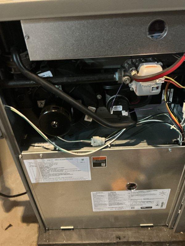 Completed comprehensive tune-up and post-installation inspection of furnace system experiencing recurring GFCI outlet trips every two months. Performed thorough examination of all electrical connections, internal components, and wiring systems to identify potential causes of power interruption. Inspected Resideo control board, motor assembly, wire harnesses, and all electrical terminations for proper installation, grounding issues, or moisture infiltration that could trigger GFCI protection. Documented system condition with detailed photography of internal components, wiring configurations, and manufacturer specifications. Verified all mechanical and electrical components operating within normal parameters during inspection period.