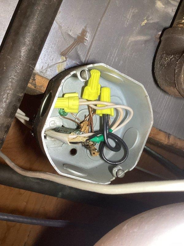 Responded to callback for furnace water leak and completed violation repair by installing outdoor GFCI receptacle within 25 feet of condenser unit per code requirements. Inspected electrical junction box wiring connections in attic space and verified proper connections with wire nuts. Thermostat operating in heating mode with system functional upon departure, with both parts and labor warranty applied to completed work.