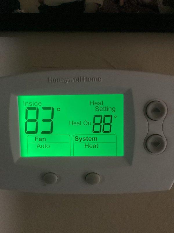 Responded to callback for furnace water leak and completed violation repair by installing outdoor GFCI receptacle within 25 feet of condenser unit per code requirements. Inspected electrical junction box wiring connections in attic space and verified proper connections with wire nuts. Thermostat operating in heating mode with system functional upon departure, with both parts and labor warranty applied to completed work.