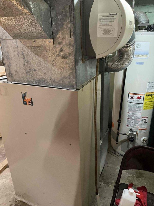 Provided estimate for complete furnace and air conditioning system replacement in basement location. Existing 40-year-old furnace currently operational but at end of service life, with no existing central air conditioning system present. Assessment included evaluation of current ductwork infrastructure, humidifier integration requirements, and spatial considerations for new equipment installation in utility room alongside existing water heater.