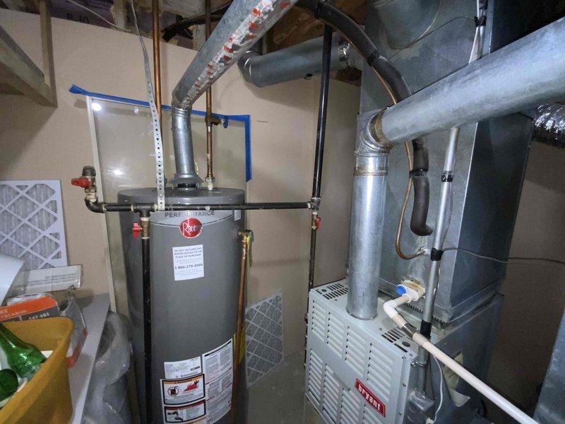 Provided comprehensive estimate for complete HVAC system replacement in basement location, including furnace and air conditioning unit. Existing equipment from 1998 remains operational but has exceeded typical service life expectancy. Documented current installation configuration with water heater, furnace, ductwork, and associated mechanical components to ensure accurate system sizing and replacement specifications for new equipment installation.
