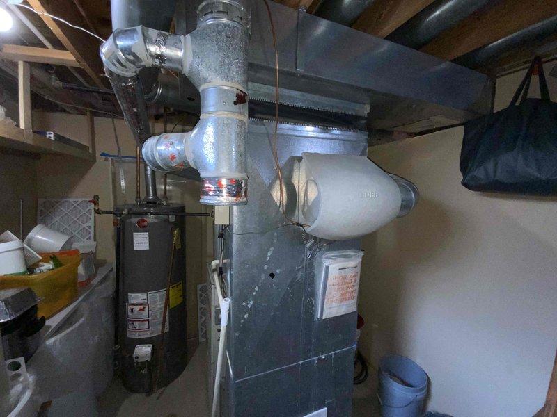Provided comprehensive estimate for complete HVAC system replacement in basement location, including furnace and air conditioning unit. Existing equipment from 1998 remains operational but has exceeded typical service life expectancy. Documented current installation configuration with water heater, furnace, ductwork, and associated mechanical components to ensure accurate system sizing and replacement specifications for new equipment installation.