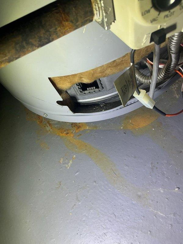 Responded to no hot water complaint and performed diagnostic inspection of tanked water heater. Upon examination, discovered significant corrosion and rust staining at the base of the unit, with visible deterioration of internal components and evidence of previous water leakage. The pilot assembly and burner chamber showed extensive mineral deposits and moisture damage, indicating the unit had experienced water intrusion compromising the heating elements and internal tank integrity. Completed diagnostic evaluation and documented findings with photographic evidence of the corroded base, deteriorated insulation, and compromised internal components for customer review and repair recommendations.