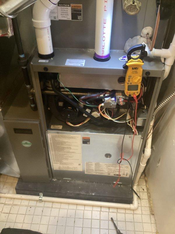 # HVAC Maintenance - AHC Completed

Performed comprehensive annual furnace maintenance on residential heating system. Conducted complete system inspection with access panels removed to assess internal components and electrical connections. Utilized multimeter to perform diagnostic testing of electrical circuits, measuring voltage and amperage to verify proper system operation. All electrical connections, wiring, and control components were inspected and found to be functioning within manufacturer specifications.

Inspected air filtration system and confirmed proper filter installation and condition. Examined honeycomb-pattern mesh filter for adequate airflow and debris accumulation. Verified blower motor housing and associated components for proper operation. Inspected condensate drain lines, PVC piping, and refrigerant line connections for secure mounting and absence of leaks.

Assessed furnace cabinet condition, burner assembly access, and all safety controls. Verified proper clearan