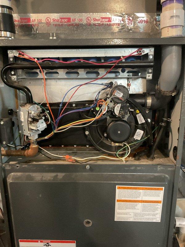 Responded to service call for 7-8 year old furnace in basement blowing cold air. Upon inspection, diagnosed faulty pressure switch preventing ignition sequence from completing. Replaced defective pressure switch, verified proper hose connections and drainage system operation, tested all safety controls, and confirmed unit returned to normal heating operation with proper temperature output.