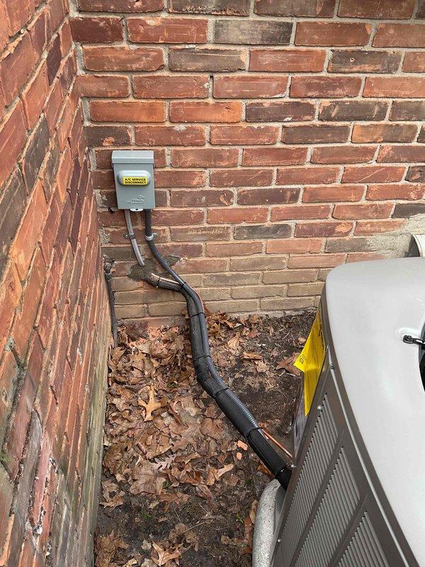 Completed full HVAC system installation including a 90,000 BTU furnace and 3-ton air conditioning unit with rear discharge configuration. Obtained mechanical and electrical permits prior to installation. Installed new furnace in basement utility area with proper PVC venting and ductwork connections. Mounted outdoor condenser unit at exterior brick wall corner with appropriate electrical disconnect box and conduit routing. Reconnected all necessary utilities and verified system operation upon completion.