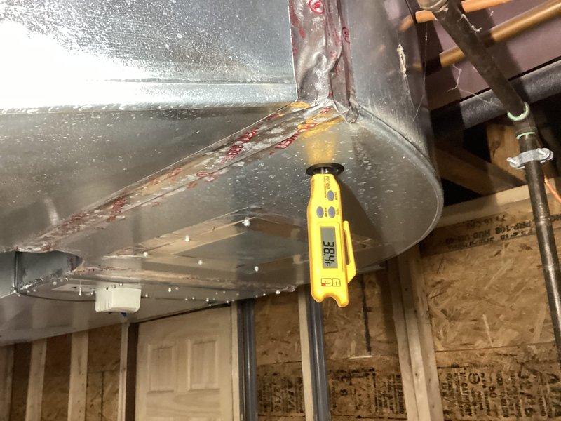 Completed annual cooling maintenance on residential HVAC system. Performed system diagnostics including supply air temperature measurements at ductwork (38.4°F recorded) and refrigerant pressure analysis using manifold gauges to verify proper system operation and charge levels. Noted visible rust staining on ductwork seams requiring future monitoring, but system operating within normal parameters at time of service.