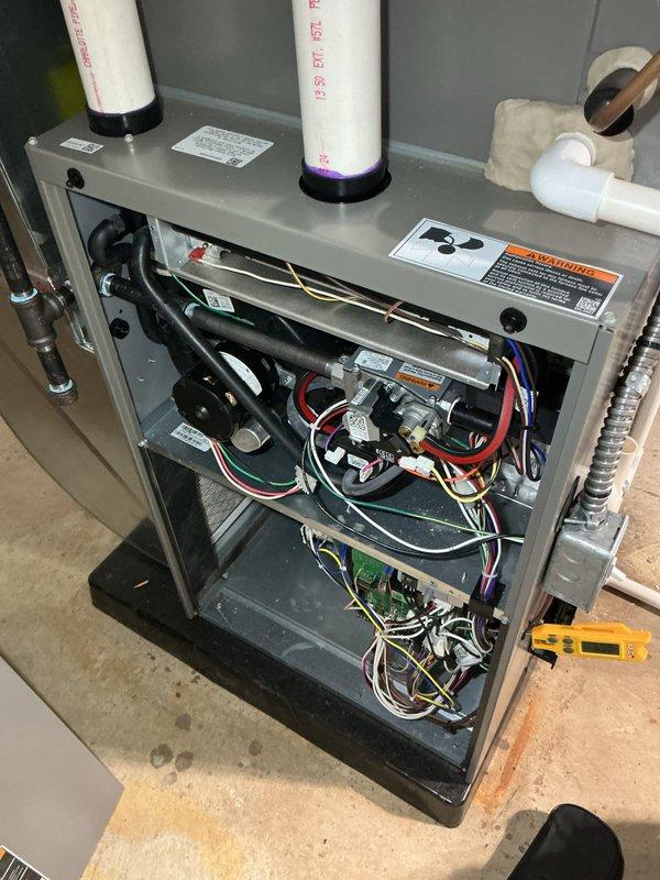 Completed annual furnace maintenance and tune-up on residential heating system. Performed comprehensive inspection of all internal components including blower motor assembly, gas valve connections, electrical wiring, and control board. Verified proper operation of ignition system and measured supply air temperature at 44°F, indicating unit was in cooling mode or standby during service. Inspected condensate drainage system with white PVC piping and vertical measurement tubes. Tested all electrical connections and safety controls to ensure proper function. All components found to be operating within normal parameters. Unit is functioning correctly and ready for continued service.