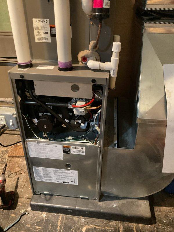 Completed scheduled Air Handler Maintenance on Lennox residential HVAC system. Opened front access panel and performed comprehensive inspection of all internal components including blower motor assembly, draft inducer motor, gas valve, burner assembly, and electrical connections. Verified proper operation of multi-port burner system and checked all wiring harnesses for secure connections and signs of wear. Inspected condensate drain lines and PVC vent piping for proper installation and drainage. Examined blower motor and secondary fan for unusual noise or vibration. Reviewed all manufacturer specification labels and safety warnings for compliance. System operating within normal parameters with no issues identified during maintenance visit.