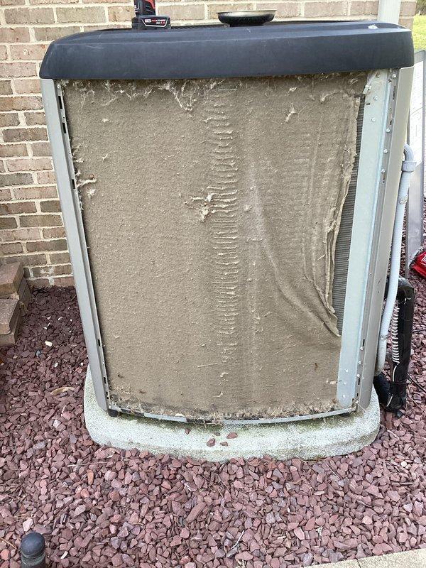 Performed annual cooling maintenance on outdoor condensing unit. Upon inspection, found heavy accumulation of dirt, dust, and debris on condenser coils and internal components. Removed front access panel and thoroughly cleaned condenser coil fins to restore proper airflow and heat transfer efficiency. Removed compacted grime and debris from interior surfaces. Verified unit operational status and cleared landscaping rock from concrete pad. System restored to optimal operating condition for cooling season.