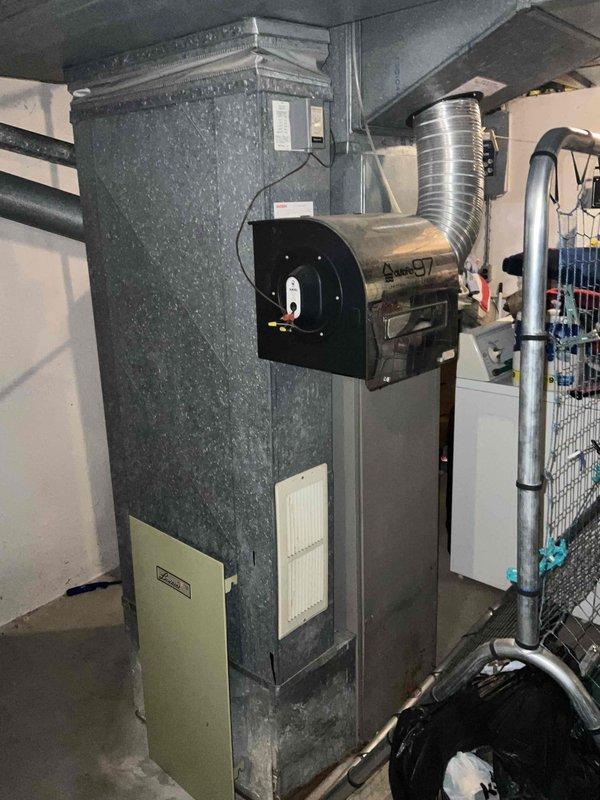 Conducted comprehensive on-site evaluation for furnace replacement at residential property. Assessed existing 40-year-old heating system, documenting current equipment configuration including air handler unit, ductwork connections, refrigerant lines, and electrical components. Photographed mechanical room layout, existing furnace installation, filter access panels, blower assembly, and associated HVAC infrastructure to provide detailed replacement estimate and system specifications for aging heating equipment.