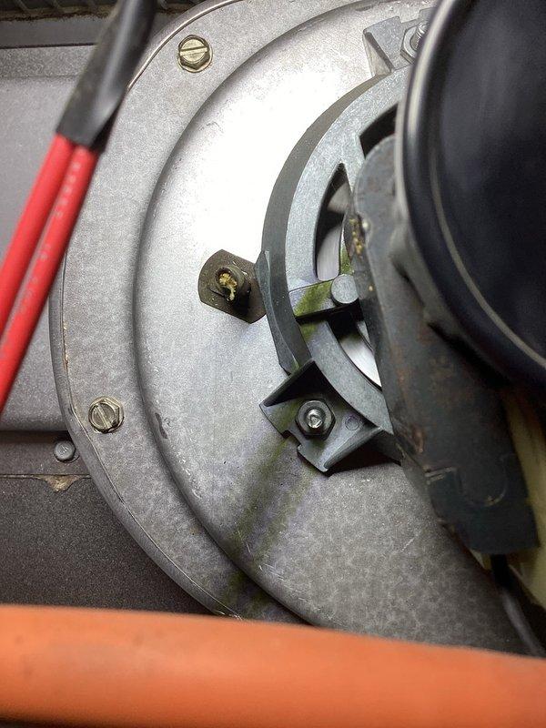 # HVAC Service Completed

Responded to no heat call on forced air furnace system. Upon arrival, confirmed heating system was not producing hot air. Performed visual inspection of furnace components including blower assembly and gas valve controls.

Inspected blower motor housing and found evidence of dust accumulation and age-related wear on metal surfaces. Examined gas valve assembly with multi-wire connections including safety and control wiring. All electrical connections to gas valve were intact with proper wire routing through housing. Verified blower motor mounting hardware and access panel security.

Photographed gas valve assembly showing Honeywell control valve with connected wiring harnesses and gas piping. Documented blower housing condition including mounting brackets and fastener placement for service records. System components showed normal operational wear consistent with equipment age.