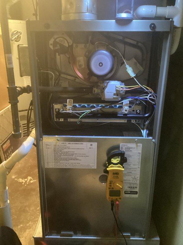 Responded to no-heat call on 9-year-old forced air furnace with burner ignition failure. Upon arrival, confirmed unit would not maintain flame and burners would not stay lit. Removed front access panel and performed diagnostic testing of gas valve, flame sensor, and ignition system using multimeter. Inspected burner assembly and heat exchanger for proper operation. Identified flame sensor rod with heavy carbon buildup and oxidation preventing proper flame rectification signal. Removed and cleaned flame sensor using emery cloth to restore conductivity. Verified proper gas pressure at manifold and tested ignition sequence. Confirmed burner ignition, flame establishment, and sustained operation through multiple heating cycles. Reinstalled access panel and restored unit to full heating operation.
