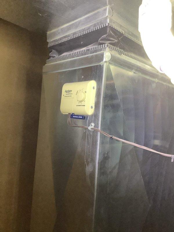 Performed diagnostic inspection of whole-home humidification system. Evaluated Aprilaire humidifier control unit mounted on main supply plenum and assessed Computer Comfort humidifier unit located in basement utility area. Documented current system configuration and operating conditions through photographic documentation to determine necessary repairs and recommend appropriate next steps for restoring proper humidity control functionality.