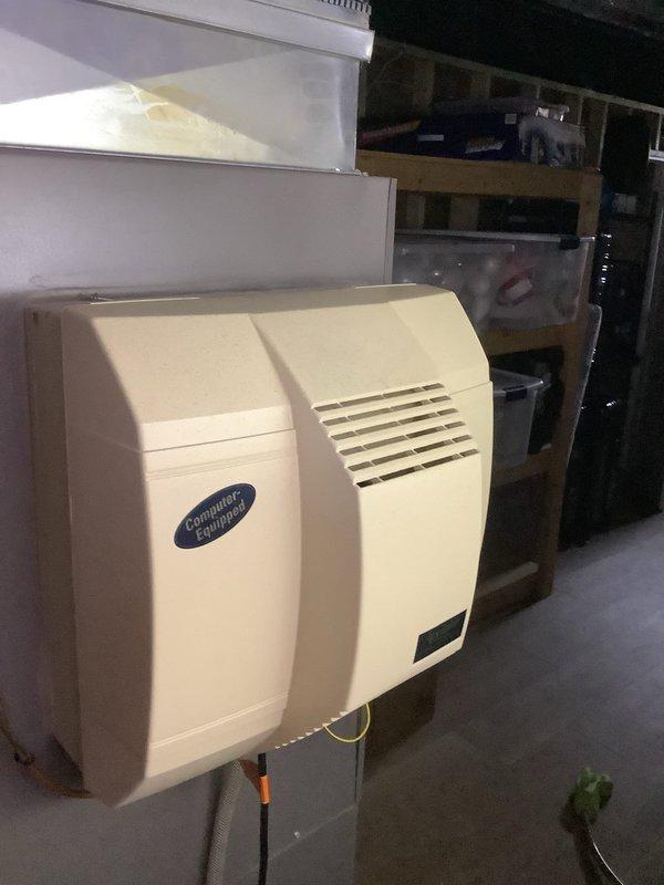 Performed diagnostic inspection of whole-home humidification system. Evaluated Aprilaire humidifier control unit mounted on main supply plenum and assessed Computer Comfort humidifier unit located in basement utility area. Documented current system configuration and operating conditions through photographic documentation to determine necessary repairs and recommend appropriate next steps for restoring proper humidity control functionality.