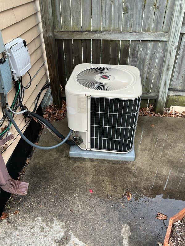 Completed scheduled Air Care Cooling maintenance on residential outdoor condenser unit. Performed comprehensive system inspection, cleared debris and leaves from around unit and concrete pad, verified proper airflow through condenser coils and top discharge grille, and confirmed electrical connections at disconnect box were secure with refrigerant lines properly insulated.
