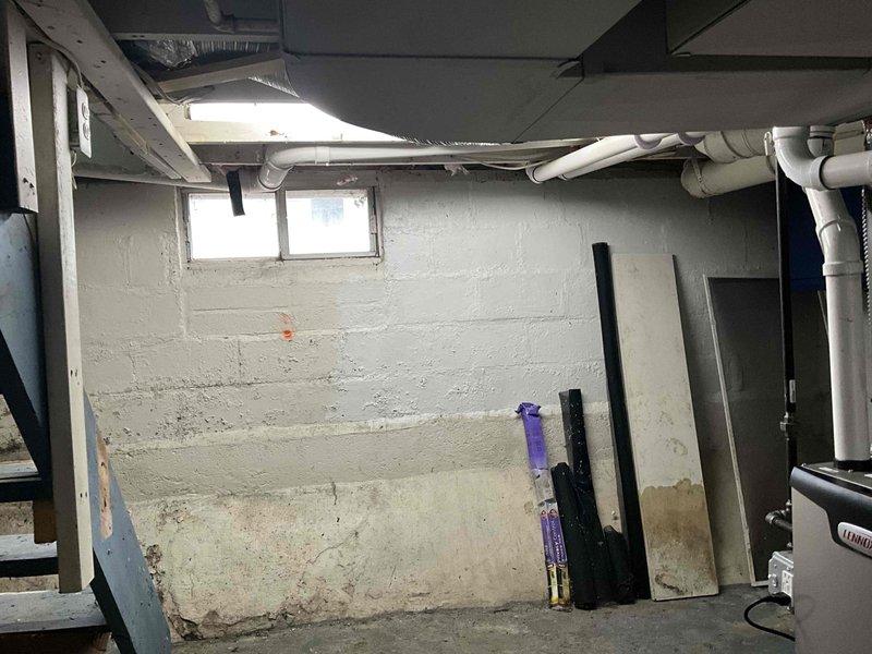 Completed commercial HVAC system installation in basement utility area. Installed new heating equipment and associated ductwork, including metallic-wrapped supply ducts and flexible duct runs. Routed white PVC condensate drainage lines along ceiling joists to ensure proper system drainage. All components tested and verified operational upon completion.