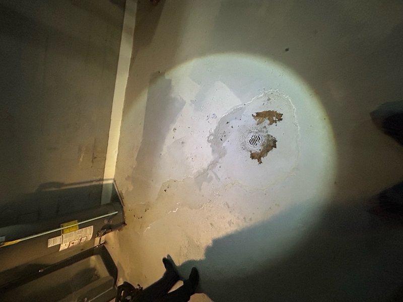 Responded to no heat call for 4-year-old forced air furnace system. Upon arrival, discovered significant water damage on basement floor near HVAC equipment location, with visible pooling and concrete deterioration around floor drain area. Investigation revealed water heater in attic space above furnace area with multiple plumbing connections showing signs of moisture. Determined that water intrusion from leaking water heater or associated plumbing had compromised furnace electrical components and safety controls. Documented extensive water damage with photographs showing affected concrete surfaces and standing water conditions. Advised immediate attention to water heater leak source and water mitigation before furnace system could be safely restored to operation, as moisture presents electrical hazard and potential for further equipment damage.