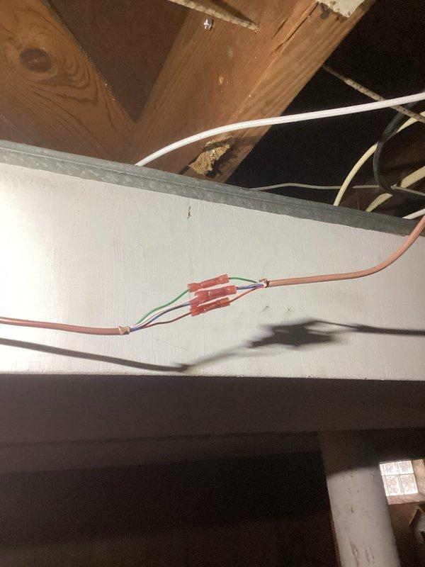 Responded to no heat call on 2017 furnace system located in basement. Previous utility company technician unable to resolve issue. Upon inspection, identified missing or failed control device affecting thermostat communication and furnace operation. Traced low-voltage wiring from thermostat through attic space to furnace control board, verified proper wire connections at thermostat base and system terminals. Replaced defective component, restored all electrical connections, and tested system operation through complete heating cycle. Unit now functioning properly with normal thermostat control and heat output.