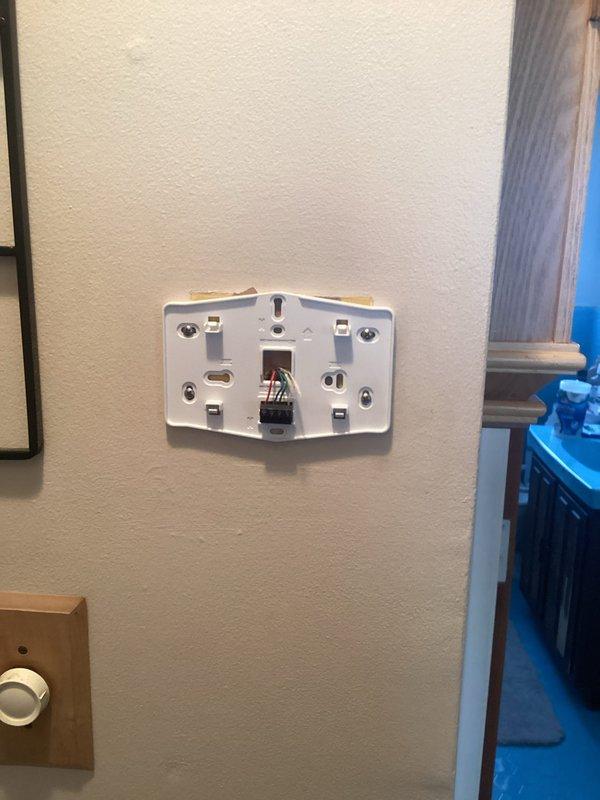 Responded to no heat call on 2017 furnace system located in basement. Previous utility company technician unable to resolve issue. Upon inspection, identified missing or failed control device affecting thermostat communication and furnace operation. Traced low-voltage wiring from thermostat through attic space to furnace control board, verified proper wire connections at thermostat base and system terminals. Replaced defective component, restored all electrical connections, and tested system operation through complete heating cycle. Unit now functioning properly with normal thermostat control and heat output.