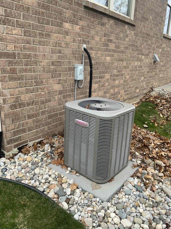 Conducted full system replacement estimate for 10-year-old Lennox HVAC system at residential property. Inspected existing outdoor condensing unit positioned against brick exterior wall, documented equipment condition including refrigerant lines, electrical disconnect, and unit placement on concrete pad with landscaping rock surround. Customer requested immediate replacement timeline, photographed current system specifications and installation configuration to provide comprehensive replacement options.