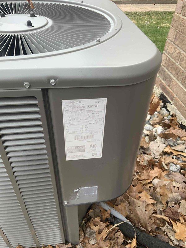 Conducted full system replacement estimate for 10-year-old Lennox HVAC system at residential property. Inspected existing outdoor condensing unit positioned against brick exterior wall, documented equipment condition including refrigerant lines, electrical disconnect, and unit placement on concrete pad with landscaping rock surround. Customer requested immediate replacement timeline, photographed current system specifications and installation configuration to provide comprehensive replacement options.