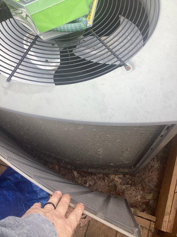 Completed annual HVAC maintenance on residential air conditioning system. Inspected condenser unit fan assembly and evaporator coil, documenting heavy dirt and debris accumulation on coil fins requiring attention. Cleared drainage area of leaf debris and organic buildup to ensure proper system drainage and prevent potential water damage or blockages.
