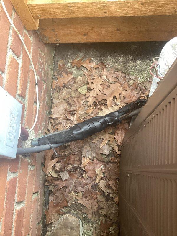 Completed annual HVAC maintenance on residential air conditioning system. Inspected condenser unit fan assembly and evaporator coil, documenting heavy dirt and debris accumulation on coil fins requiring attention. Cleared drainage area of leaf debris and organic buildup to ensure proper system drainage and prevent potential water damage or blockages.