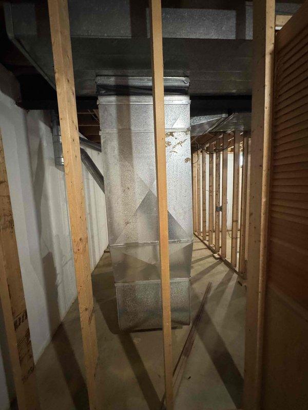 Provided estimate for complete HVAC system replacement in basement location, including natural gas furnace and air conditioning unit. Current 25-year-old AC system is non-operational while existing furnace remains functional. Assessment included evaluation of existing ductwork infrastructure and equipment accessibility in unfinished basement space with exposed framing and concrete flooring.