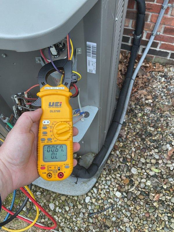 Performed annual cleaning and maintenance on outdoor HVAC unit. Condenser coil fins were found heavily clogged with dirt, dust, and debris accumulation, significantly restricting airflow. Thoroughly cleaned condenser coils to restore proper heat transfer efficiency. Conducted electrical diagnostics using clamp meter to verify system amperage and confirm proper operation of all electrical components.