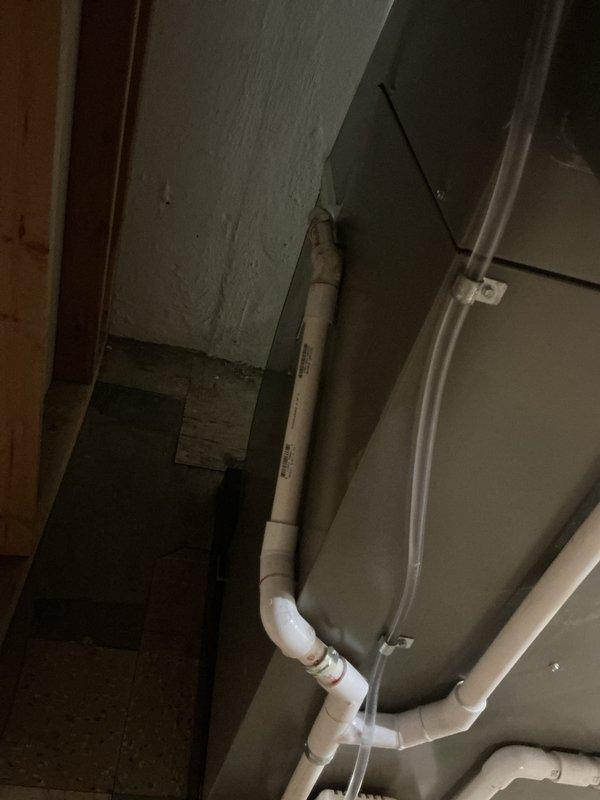 Completed full HVAC system installation including a 70,000 BTU furnace with humidifier and liner, 2-ton rear-discharge air conditioning unit, and hot water heater replacement in basement utility space. All equipment mounted on appropriate platforms with PVC venting routed through ceiling joists, copper supply lines connected, and condensate drainage properly configured. Mechanical and electrical permits obtained prior to installation, all units tested and operational upon completion with reconnection of existing ductwork system.